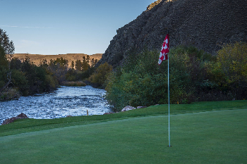 green with scenic river in the background