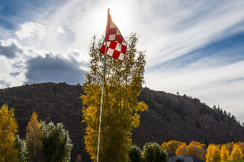 golf flag against a cloudy sky